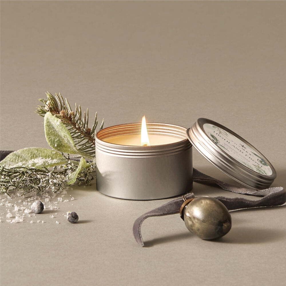 Thymes Highland Frost Travel Tin Candle open and lit  image number 1